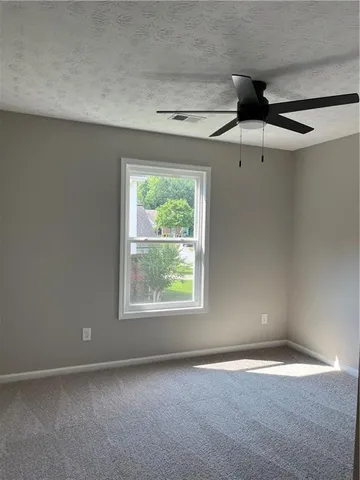 an empty room with a empty space and a ceiling fan