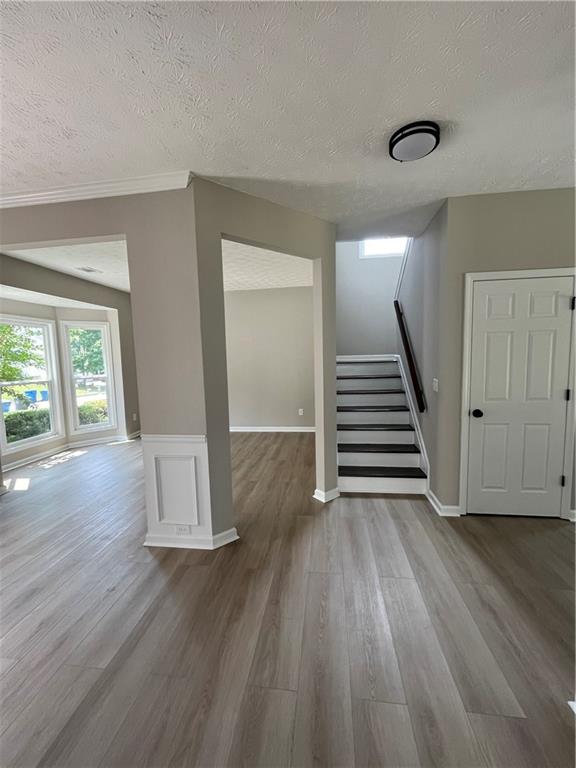 2147 St Albans Place Buford, GA 30519 - Photo 3 of 29 a view of a livingroom with wooden floor and stairs