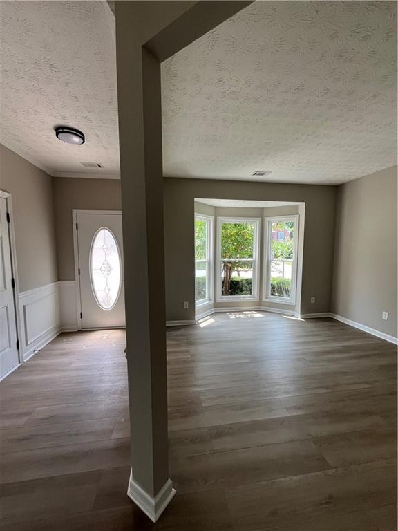 2147 St Albans Place Buford, GA 30519 - Photo 5 of 29 a view of an empty room with wooden floor and a window