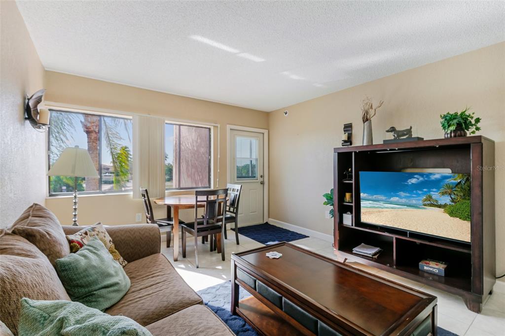 3170 Matecumbe Road, Unit 127 Punta Gorda, FL 33955 - Photo 4 of 20 a living room with furniture a flat screen tv and a window