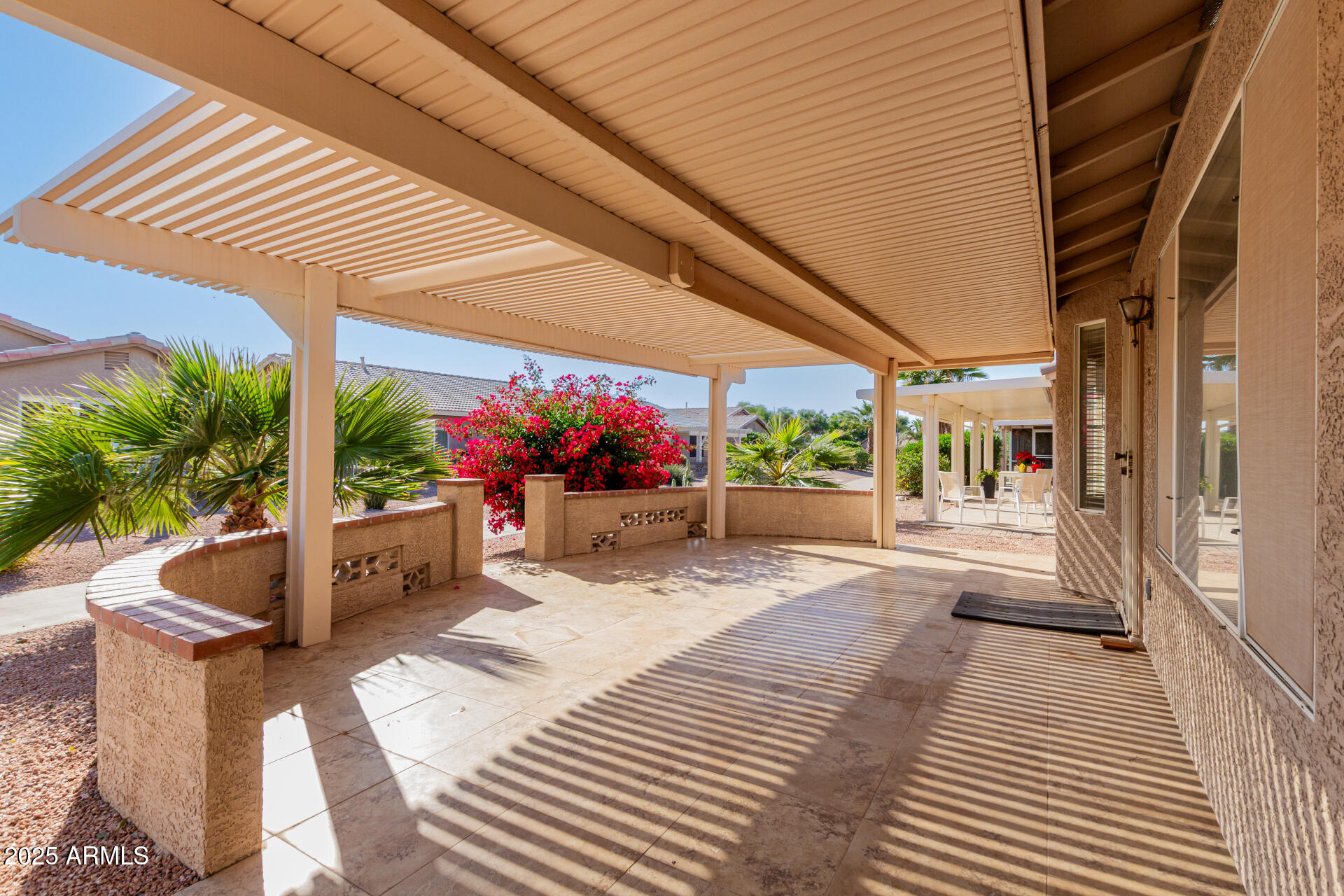 1475 East Riviera Drive Chandler, AZ 85249 - Photo 17 of 22 a view of a patio with table and chairs potted plants and floor to ceiling window