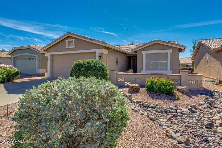 1475 East Riviera Drive Chandler, AZ 85249 - Photo 2 of 22 a front view of a house with garden