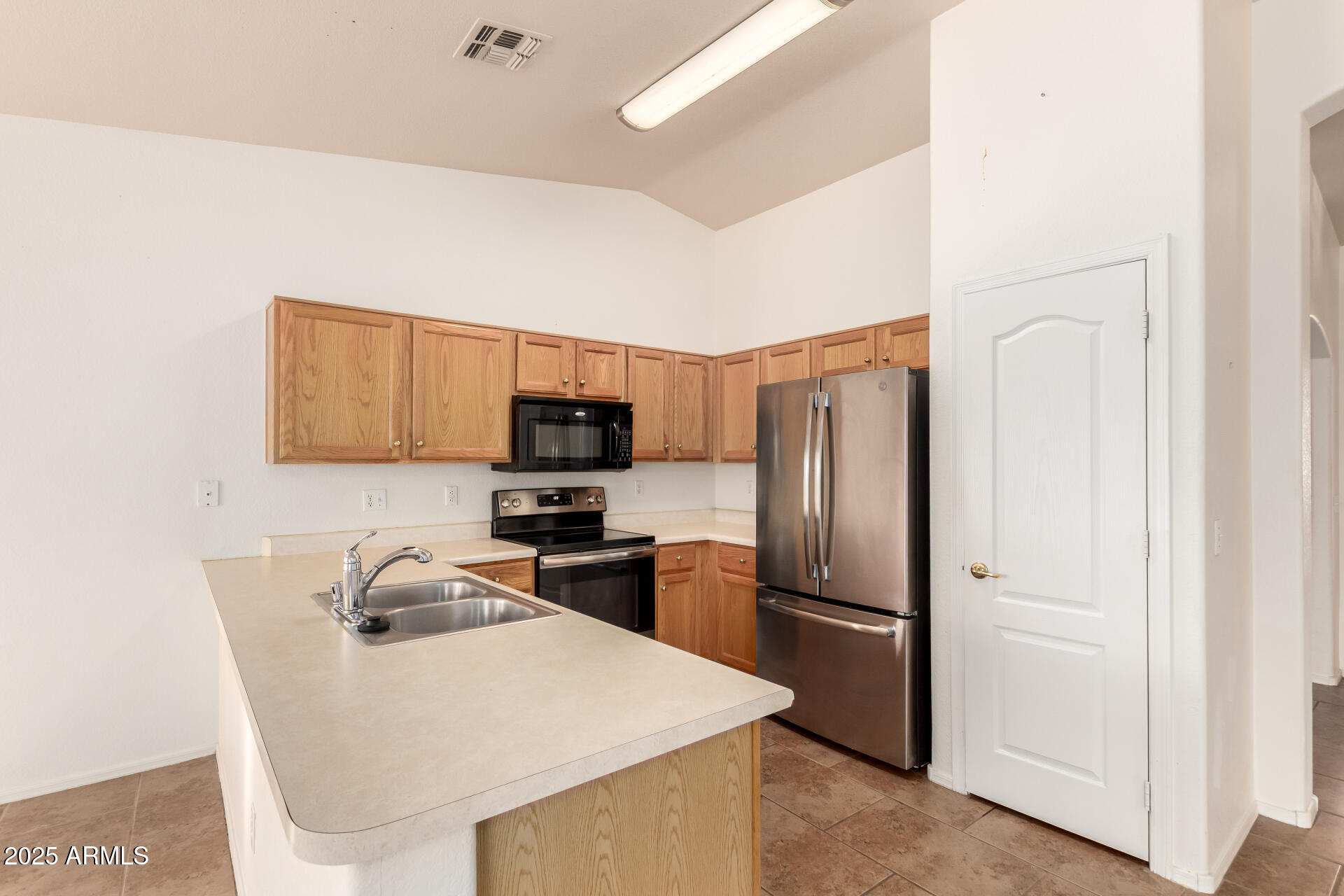1475 East Riviera Drive Chandler, AZ 85249 - Photo 7 of 22 a kitchen with stainless steel appliances a refrigerator stove microwave and sink