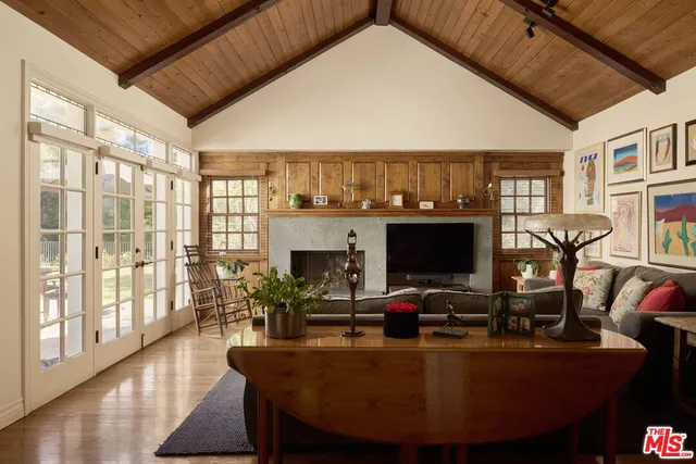 a living room with fireplace furniture and a flat screen tv