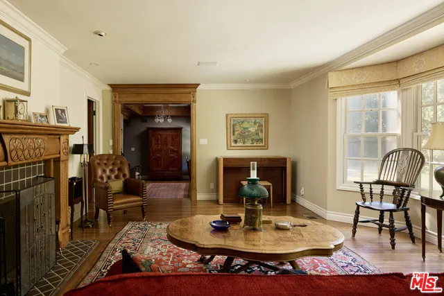 a living room with fireplace furniture and a table