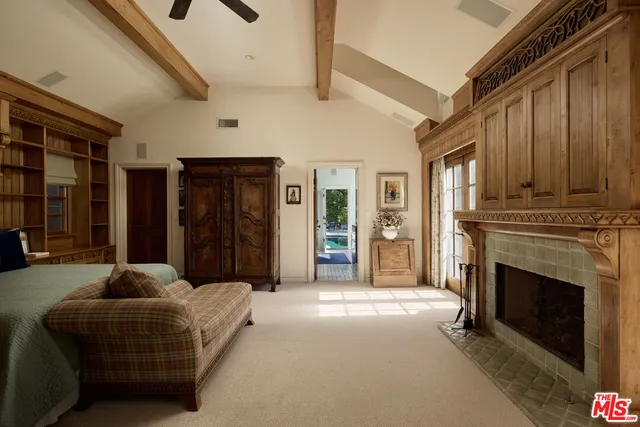 a living room with furniture a fireplace and a ceiling fan
