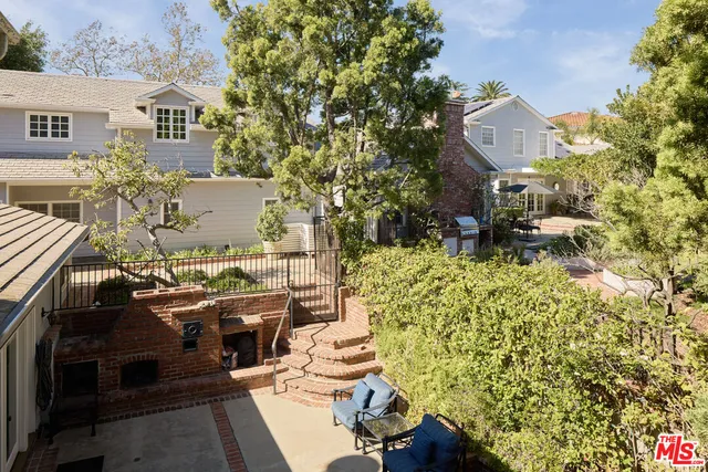 an aerial view of a house with a yard fire pit and furniture