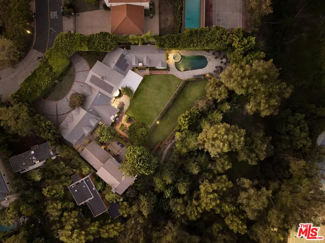 an aerial view of a house with outdoor space