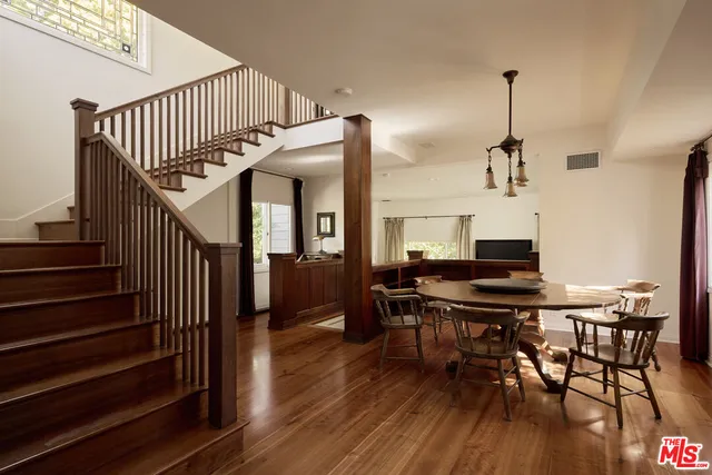 a view of a dining room with furniture wooden floor and a chandelier