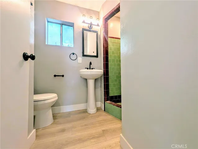 a bathroom with a toilet sink and mirror