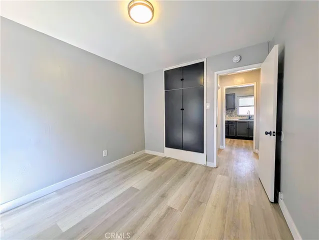 a view of hallway with wooden floor