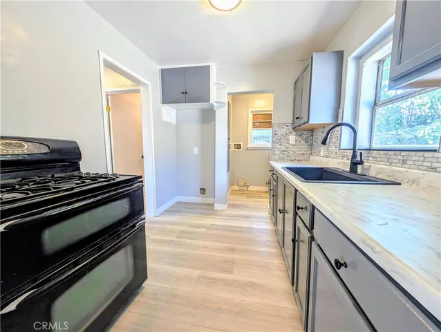 a kitchen with a stove and a sink