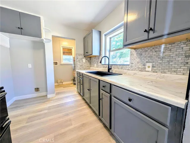a kitchen with stainless steel appliances granite countertop a sink and a stove
