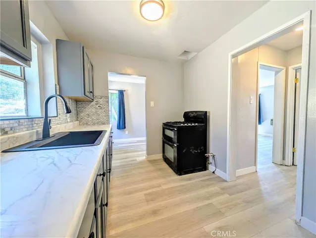 a kitchen with stainless steel appliances granite countertop a refrigerator and a sink