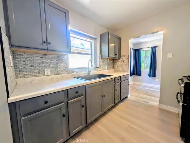 a spacious bathroom with a granite countertop sink and a large mirror