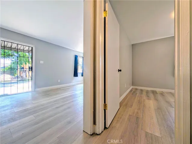 a view of hallway with wooden floor