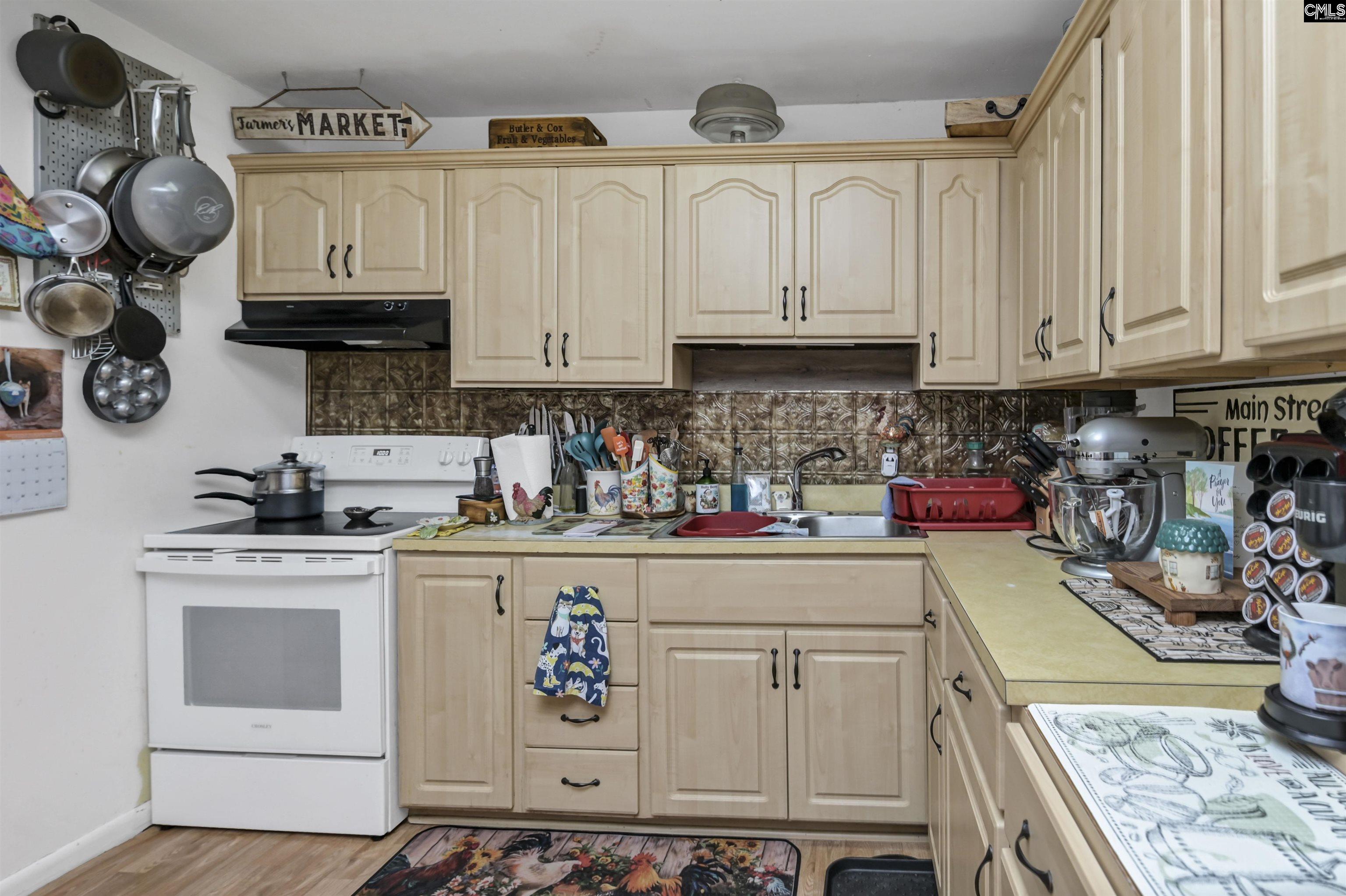 133 Sunset Strip Elgin, SC 29045 - Photo 14 of 30 a kitchen with granite countertop white cabinets and white appliances