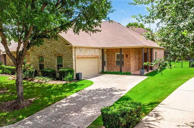 a front view of a house with a garden and plants