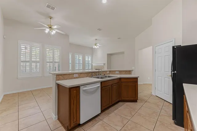 a kitchen with stainless steel appliances granite countertop a stove and a refrigerator