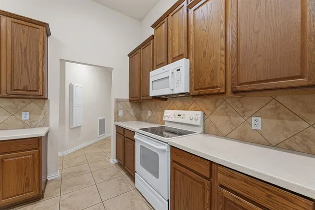 a kitchen with a stove and a microwave
