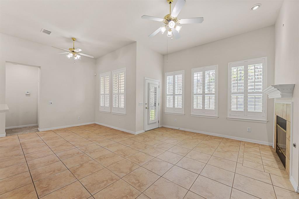 719 Scenic Ranch Circle Fairview, TX 75069 - Photo 13 of 36 a view of an empty room with a fireplace and a window