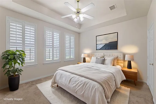 an empty room with windows and ceiling fan