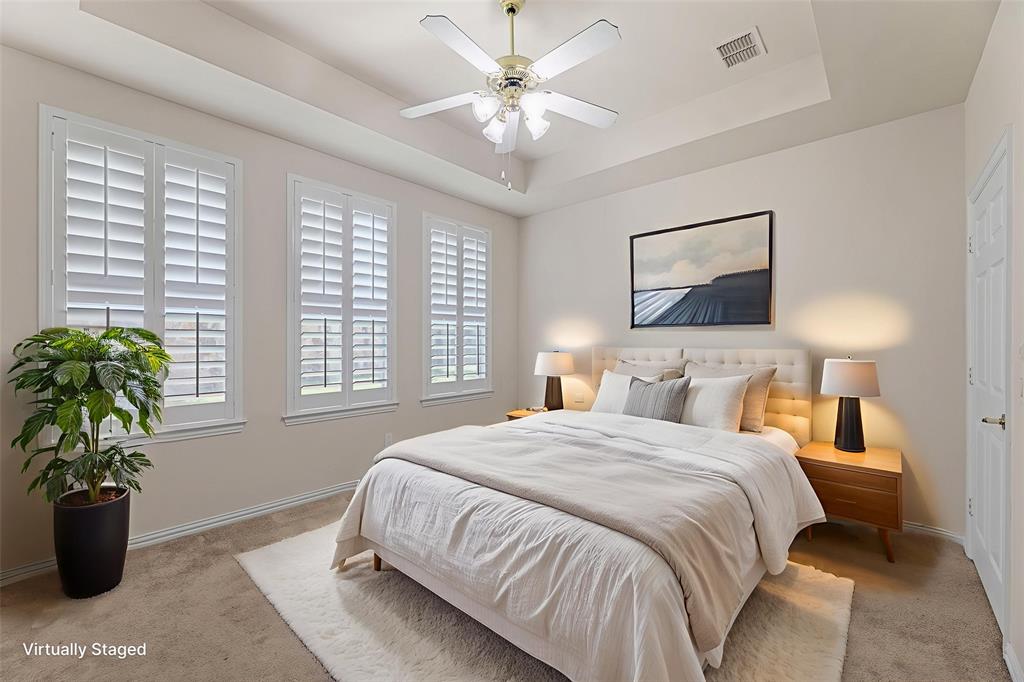 719 Scenic Ranch Circle Fairview, TX 75069 - Photo 20 of 36 a bedroom with a large bed and a chandelier