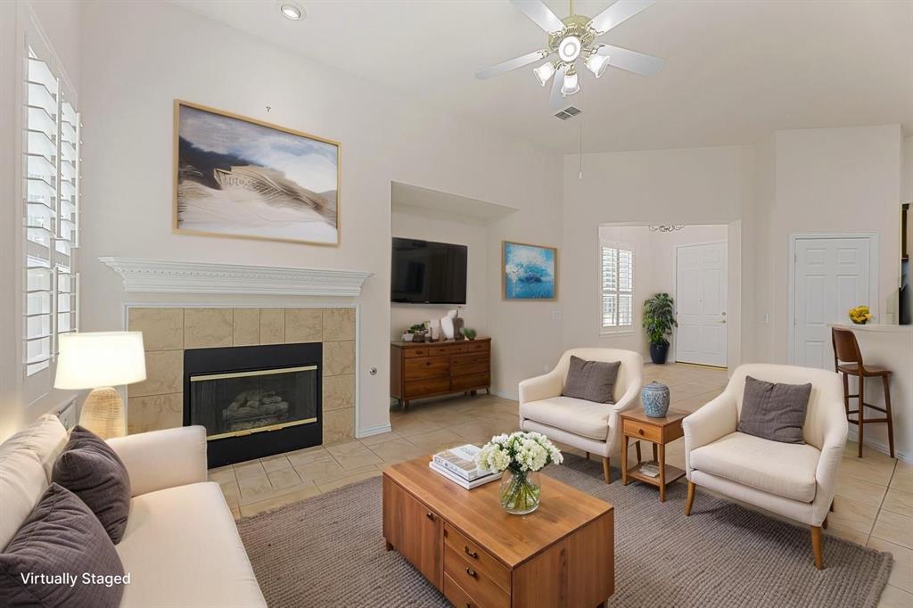 719 Scenic Ranch Circle Fairview, TX 75069 - Photo 2 of 36 a living room with furniture a fireplace and a flat screen tv