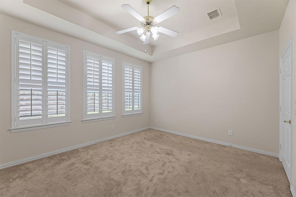 719 Scenic Ranch Circle Fairview, TX 75069 - Photo 21 of 36 an empty room with windows and ceiling fan