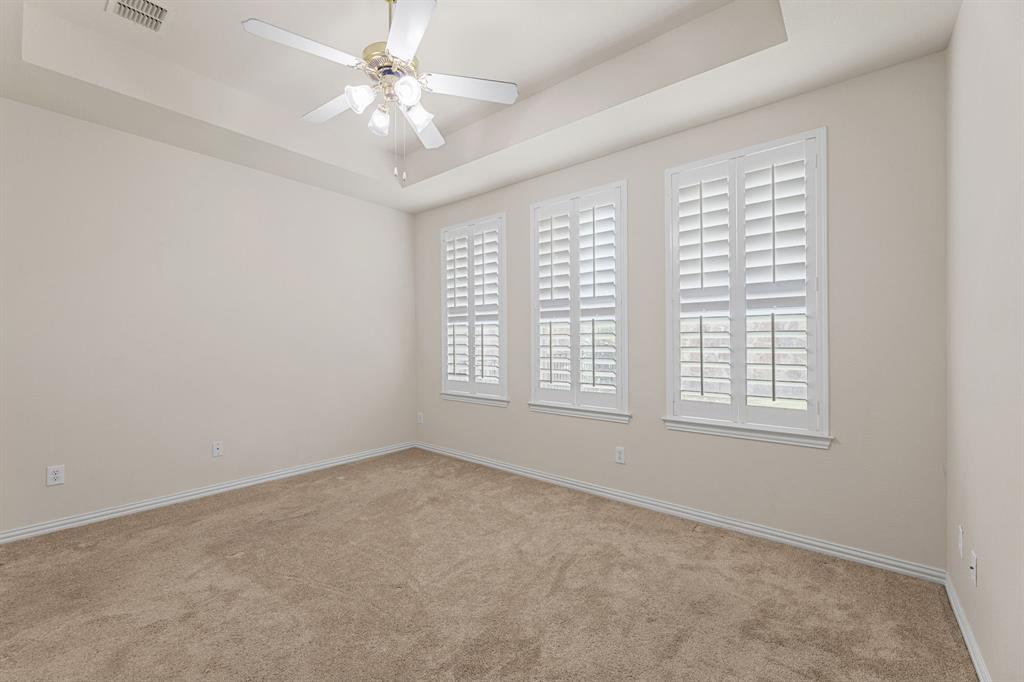 719 Scenic Ranch Circle Fairview, TX 75069 - Photo 22 of 36 an empty room with windows and ceiling fan