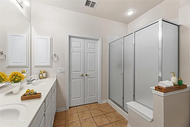 a bathroom with a sink double vanity and a tub