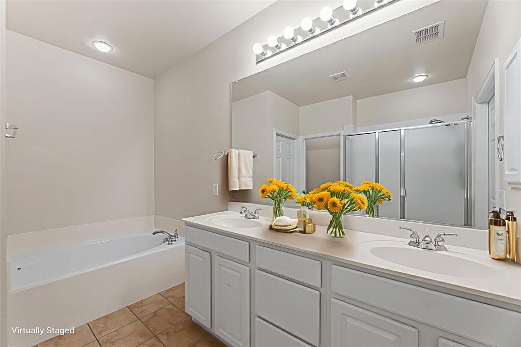 719 Scenic Ranch Circle Fairview, TX 75069 - Photo 24 of 36 a bathroom with a sink double vanity and a tub