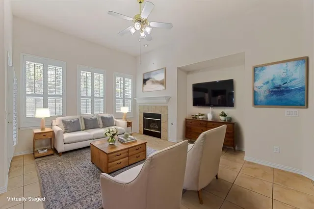 a living room with fireplace furniture and a flat screen tv