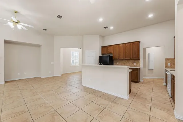 a view of a kitchen with microwave and cabinets