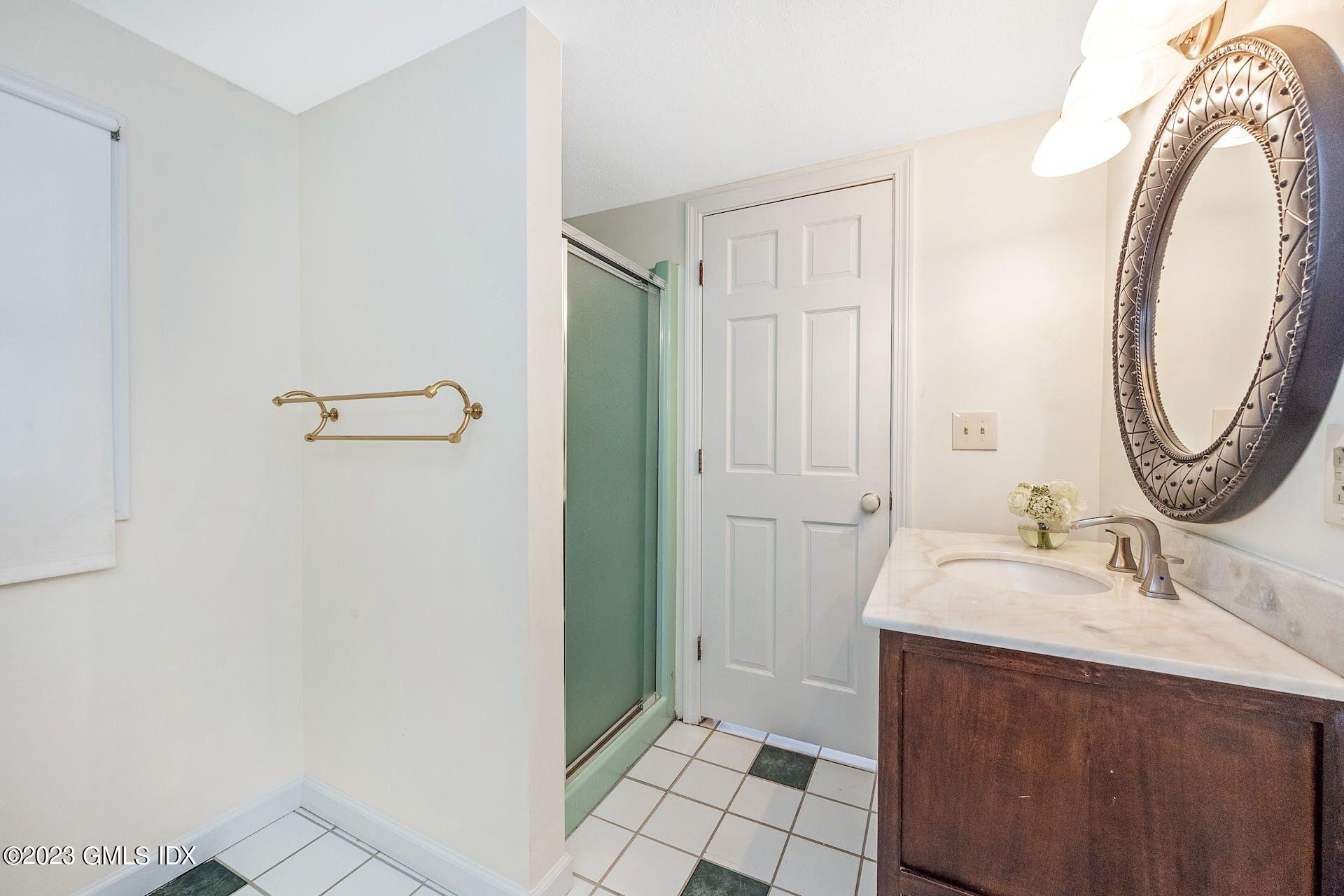 52 Hendrie Avenue Riverside, CT 06878 - Photo 24 of 30 a bathroom with a sink and a mirror