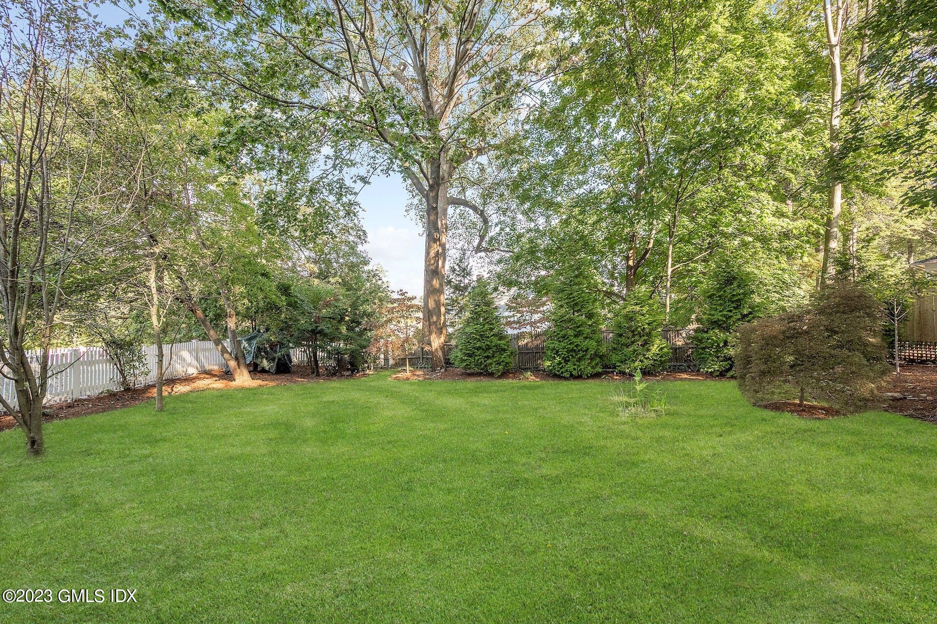 52 Hendrie Avenue Riverside, CT 06878 - Photo 25 of 30 a view of a grassy field with trees in the background