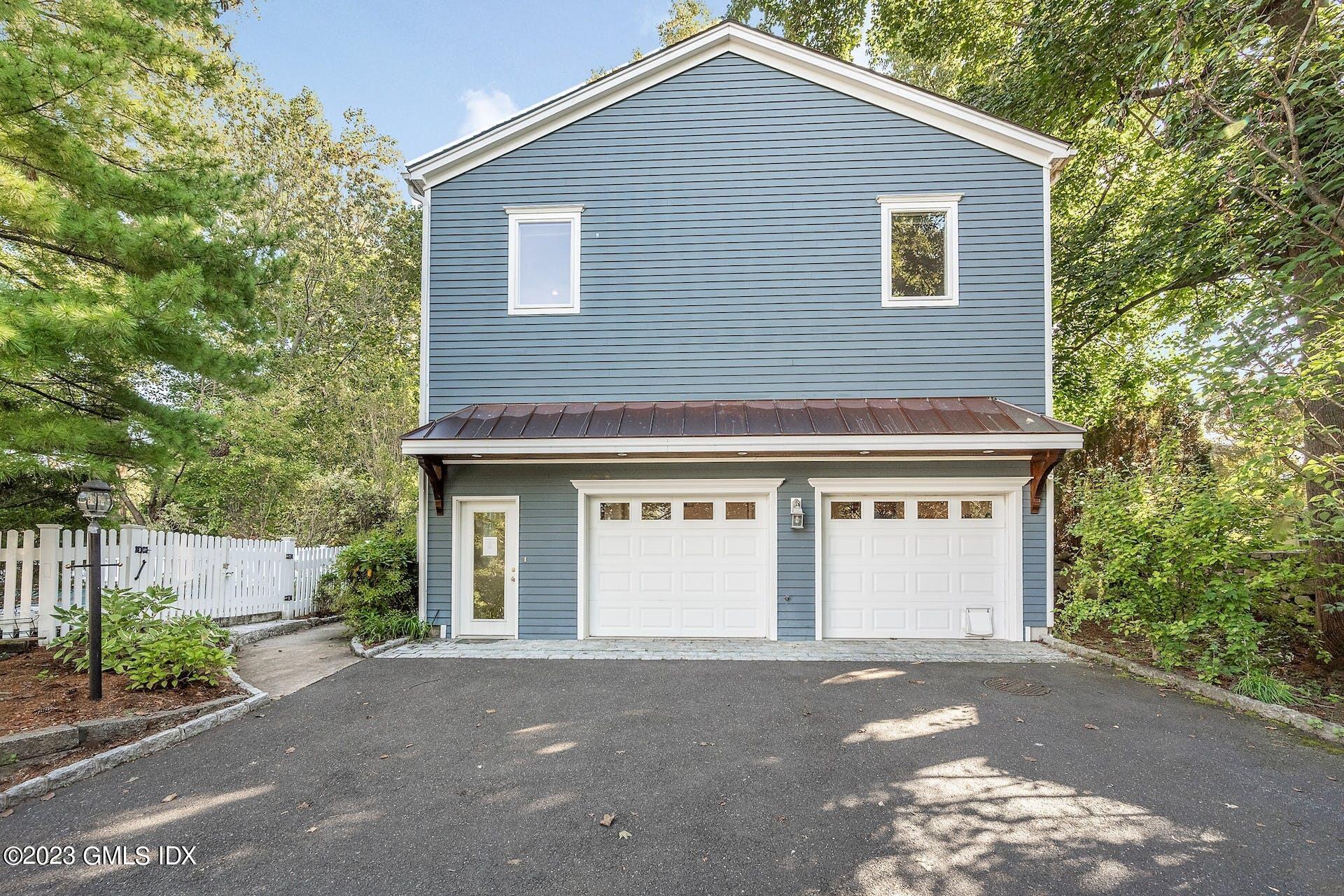 52 Hendrie Avenue Riverside, CT 06878 - Photo 30 of 30 a front view of a house with a yard and garage