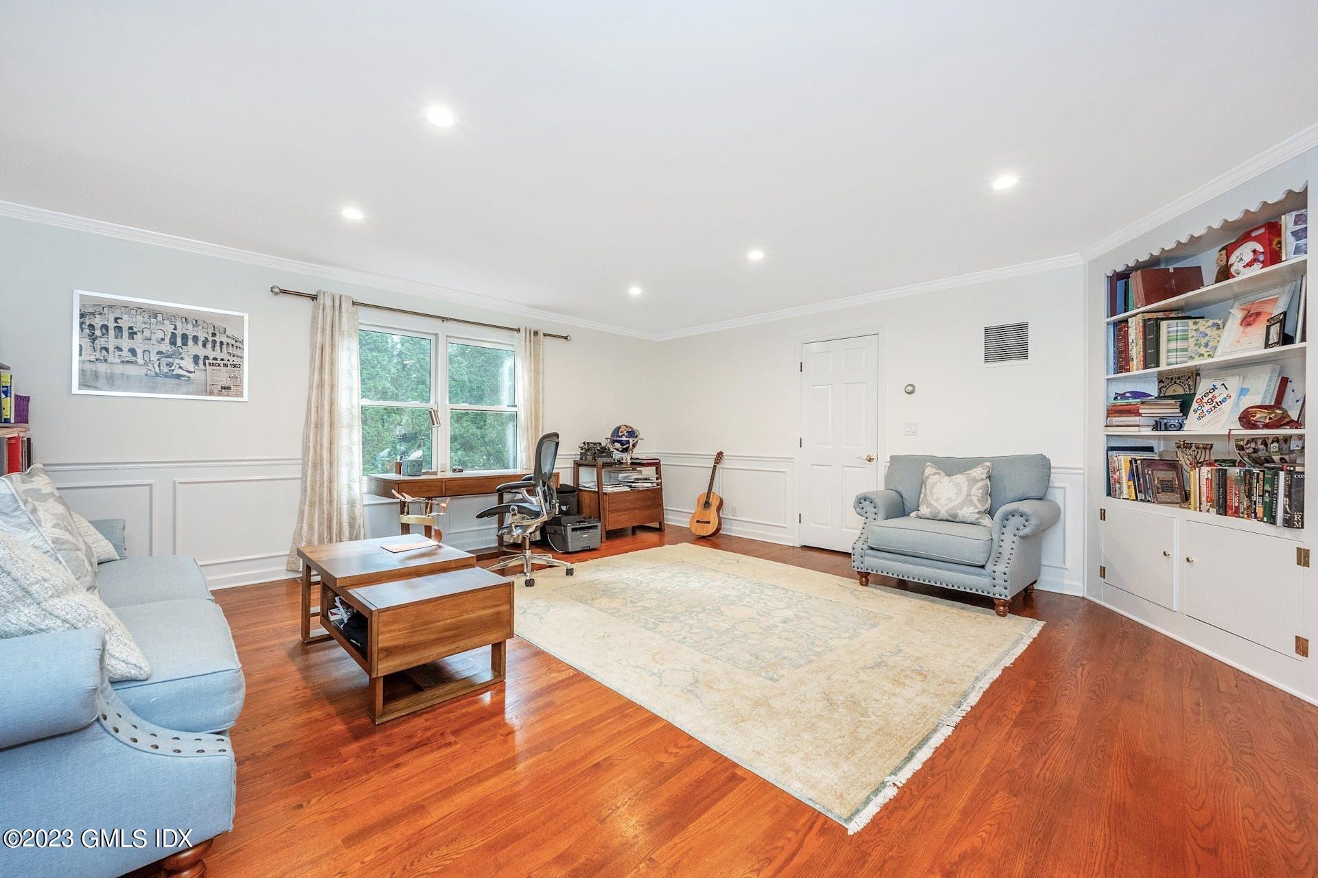 52 Hendrie Avenue Riverside, CT 06878 - Photo 5 of 30 a living room with furniture and a book shelf