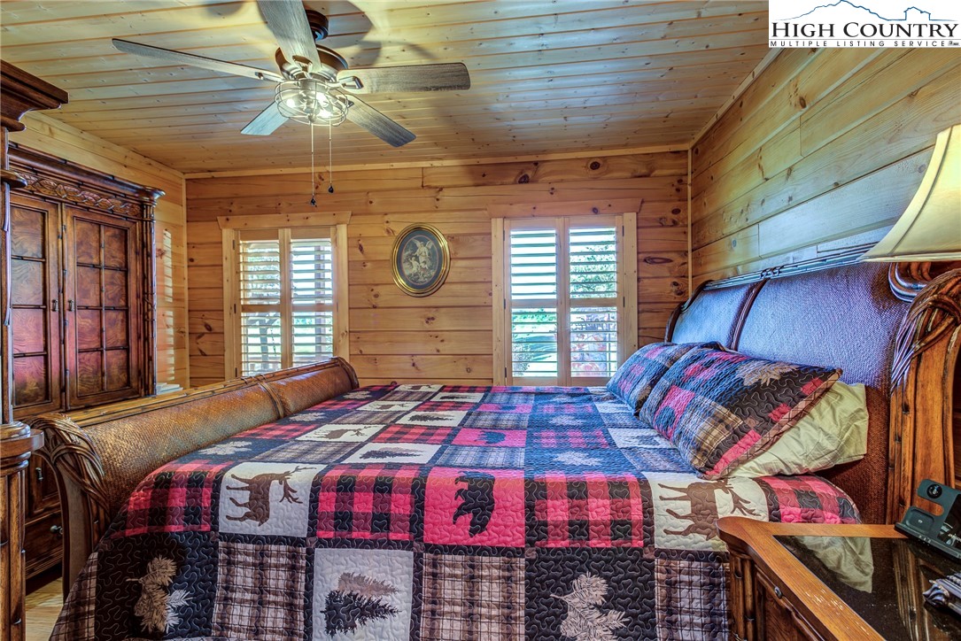 3460 South Center Church Road Thurmond, NC 28683 - Photo 27 of 50 a bedroom with a bed and a chandelier