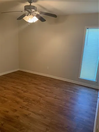a view of a room with wooden floor and a window