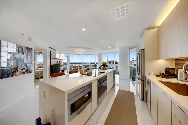 a kitchen with a sink a stove and refrigerator