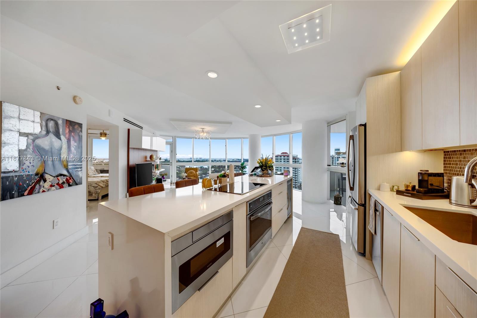 6301 Collins Avenue, Unit 2107 Miami Beach, FL 33141 - Photo 11 of 42 a kitchen with a sink a stove and refrigerator