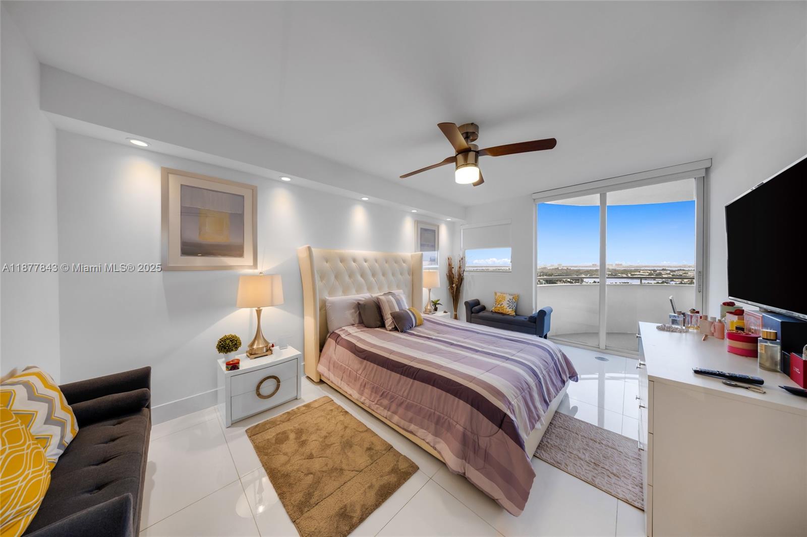 6301 Collins Avenue, Unit 2107 Miami Beach, FL 33141 - Photo 15 of 42 a bedroom with a bed a window and a flat screen tv