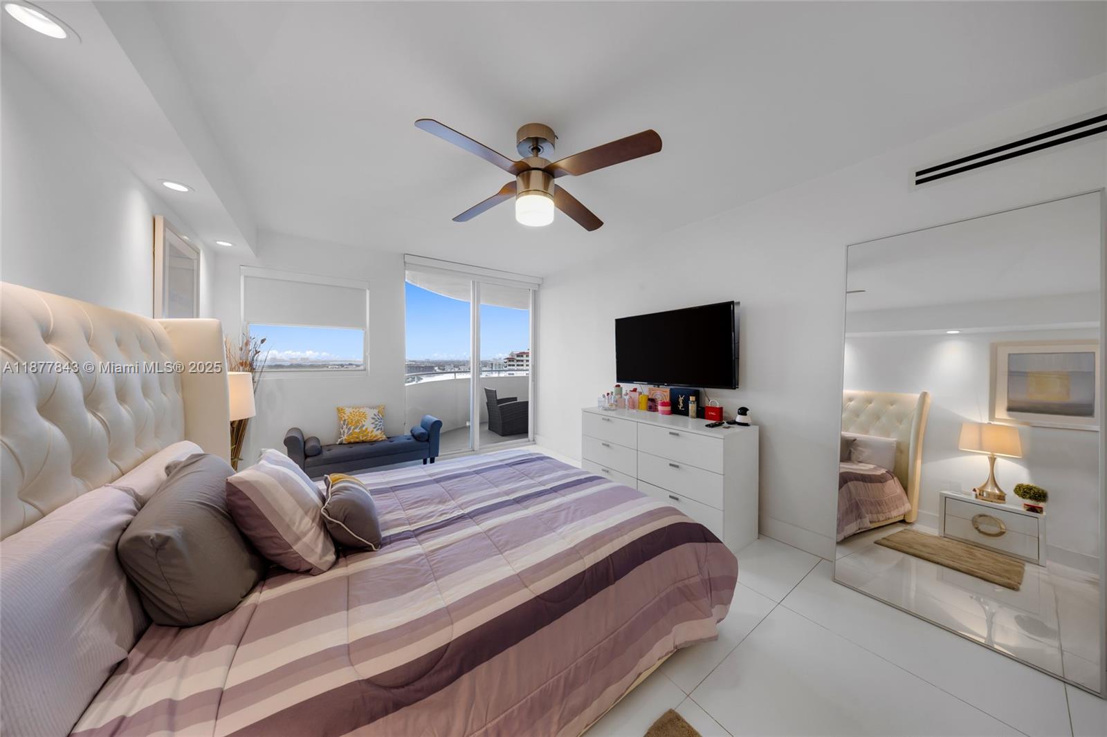 6301 Collins Avenue, Unit 2107 Miami Beach, FL 33141 - Photo 16 of 42 a bedroom with a bed and a flat screen tv