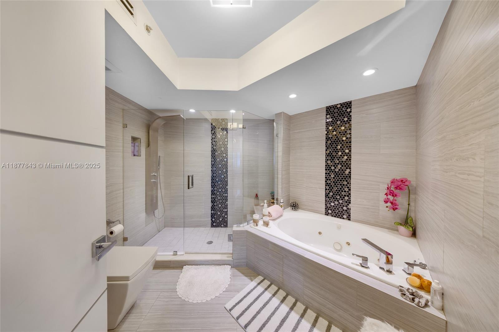 6301 Collins Avenue, Unit 2107 Miami Beach, FL 33141 - Photo 19 of 42 a bathroom with a tub a sink and a large mirror