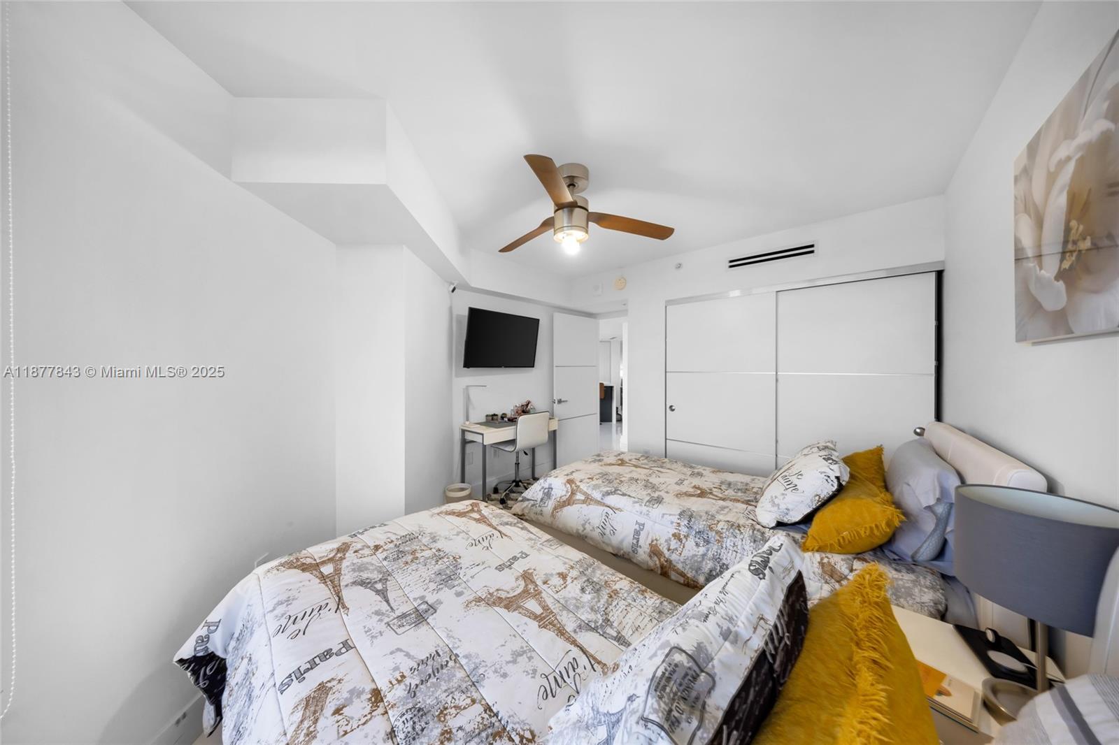 6301 Collins Avenue, Unit 2107 Miami Beach, FL 33141 - Photo 22 of 42 a bedroom with a bed and a flat screen tv