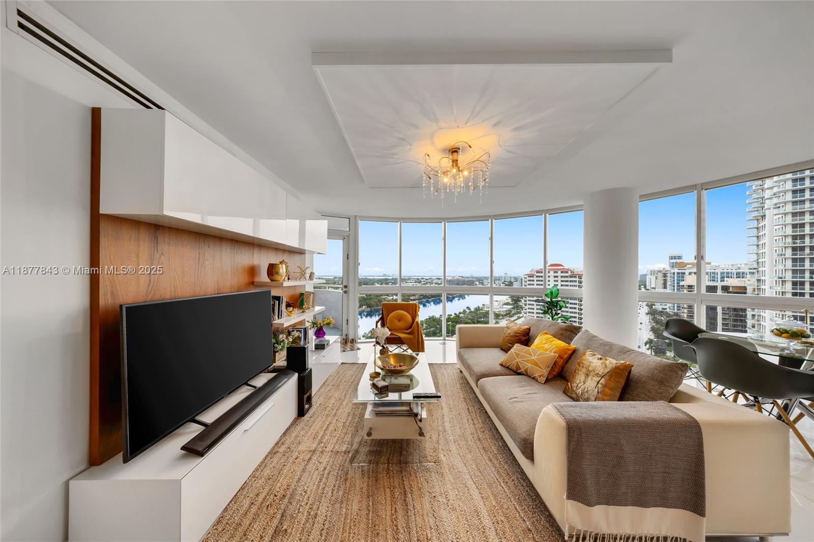 6301 Collins Avenue, Unit 2107 Miami Beach, FL 33141 - Photo 5 of 42 a living room with furniture and a flat screen tv