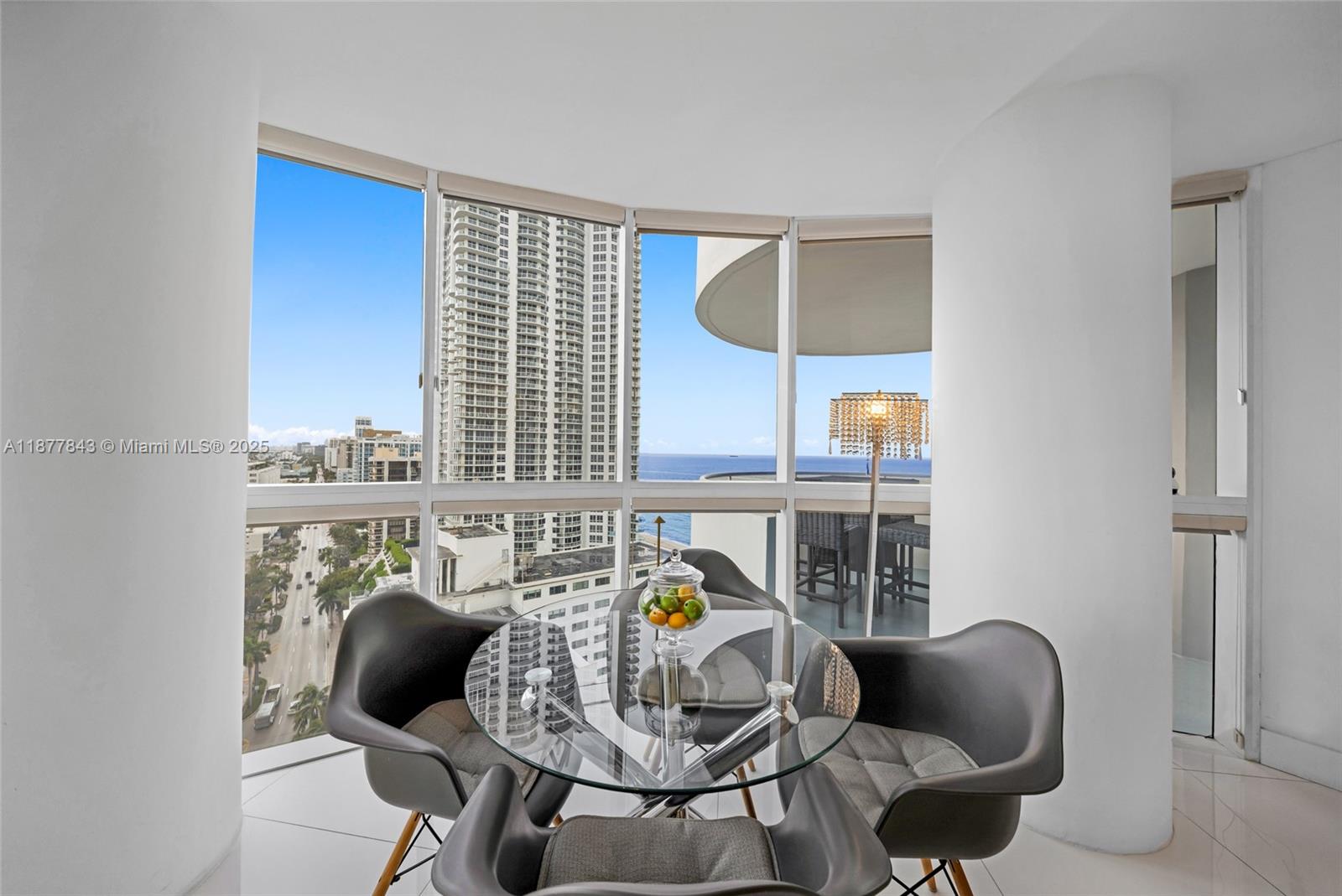 6301 Collins Avenue, Unit 2107 Miami Beach, FL 33141 - Photo 8 of 42 a dining room with furniture and wooden floor