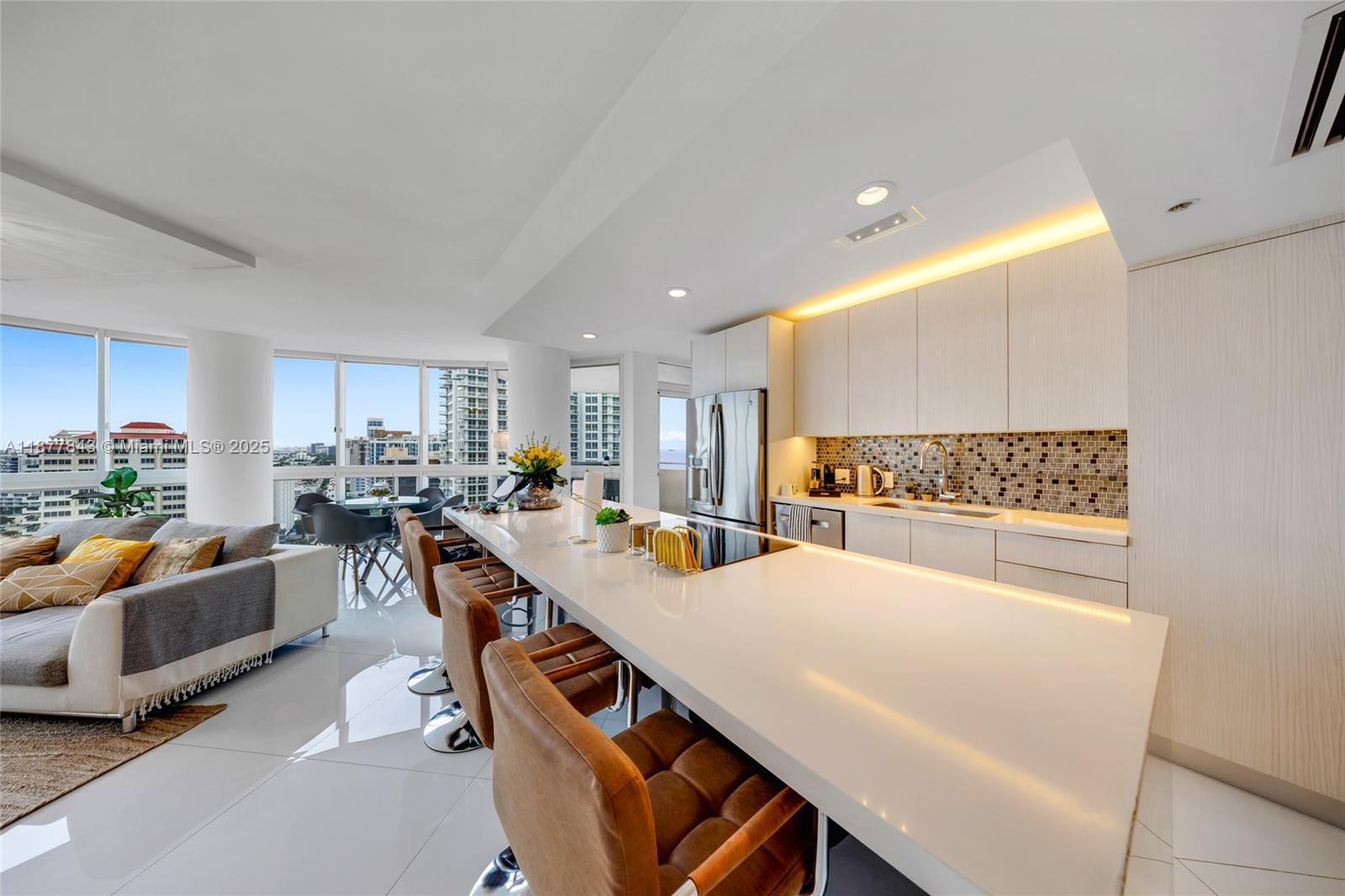 6301 Collins Avenue, Unit 2107 Miami Beach, FL 33141 - Photo 10 of 42 a view of a dining room with furniture and a kitchen