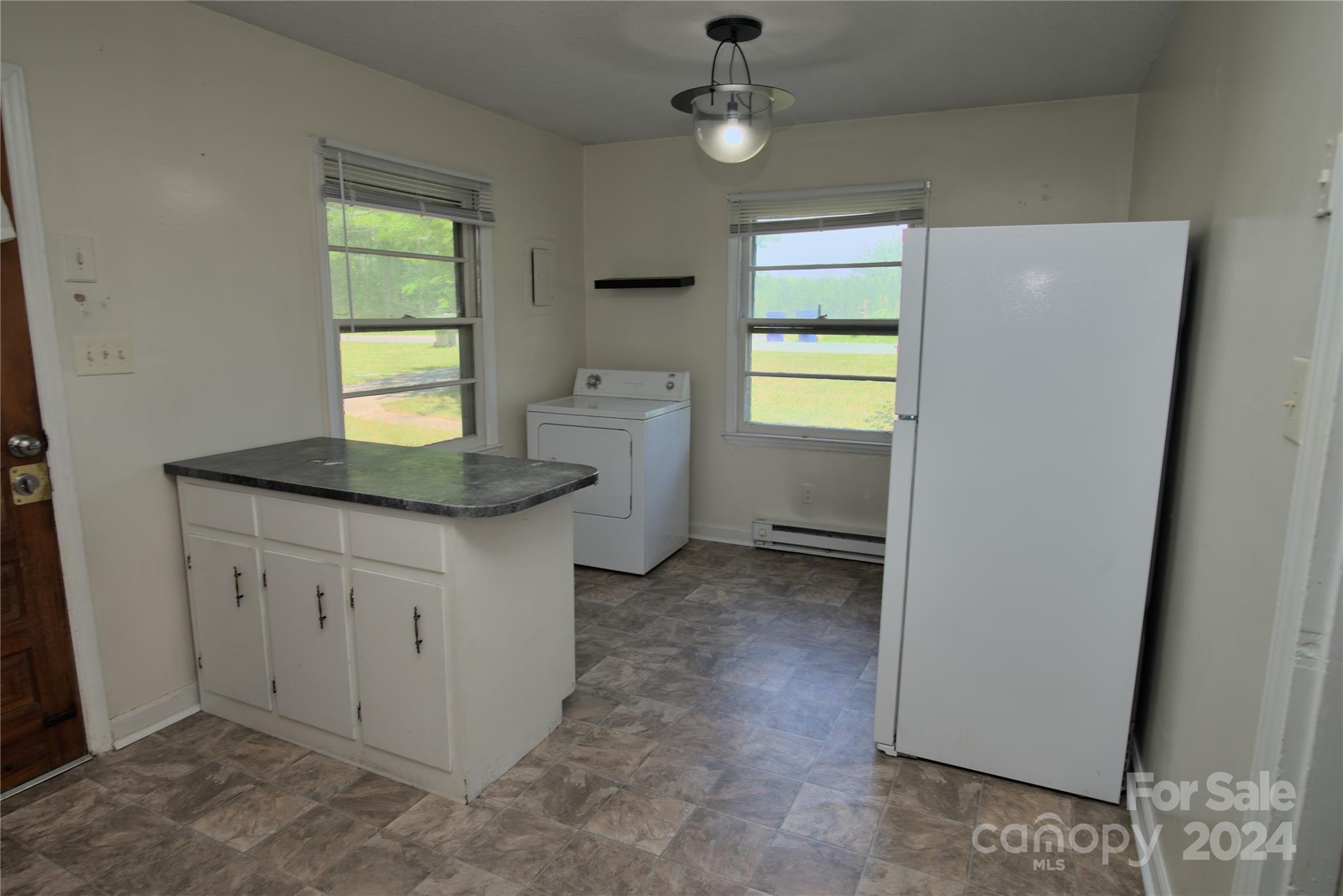 14903 Beatties Ford Road Huntersville, NC 28078 - Photo 11 of 25 a kitchen with granite countertop cabinets a sink a window and appliances